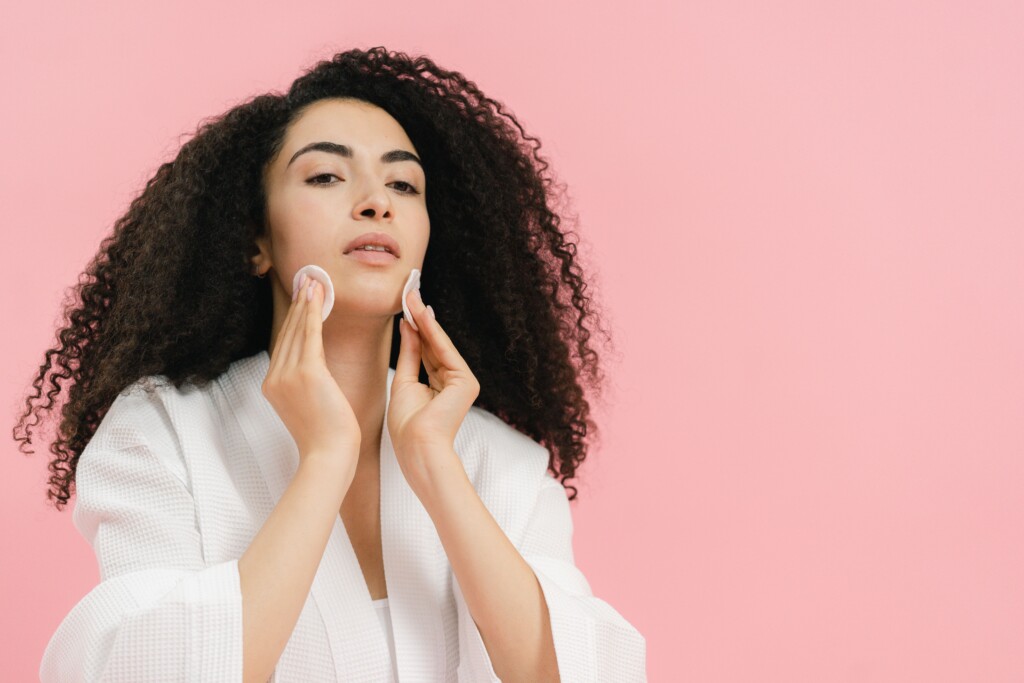 Donna durante la detersione del viso, passaggio centrale della skincare anti smog per chi vive in città